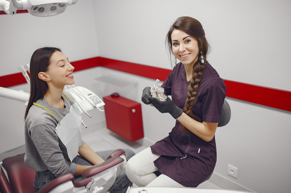 A Beautiful girl sitting in a dentist office