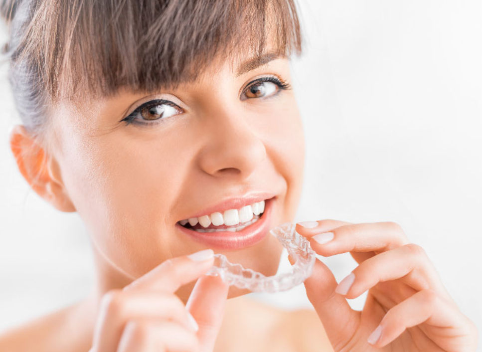 A beautiful woman showing her Invisalign A beautiful woman showing her Invisalign