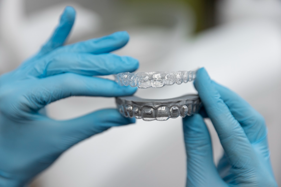 Close up of taking imprint of teeth on mail order aligner