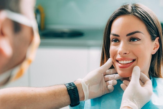 A Dentist Evaluating the Oral Condition of a Patient at Her Full
  Mount Dental Implants Cost Consultation    A Dentist Evaluating the Oral Condition of a Patient at Her Full
  Mount Dental Implants Cost Consultation