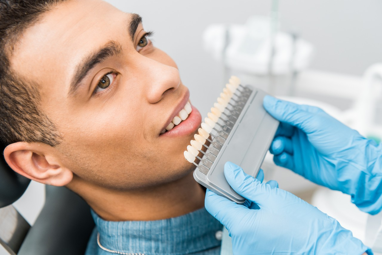 A man receives dental cosmetic treatment at Smile Cafe for teeth whitening. A man receives dental cosmetic treatment at Smile Cafe for teeth whitening.