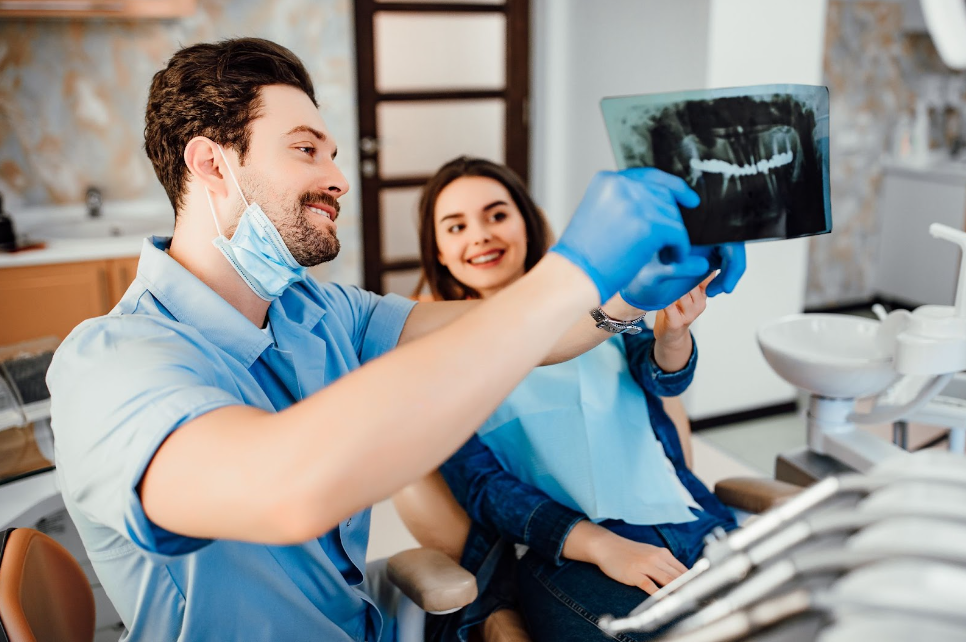 Dentistry showing his female patient the treatment process Dentistry showing his female patient the treatment process