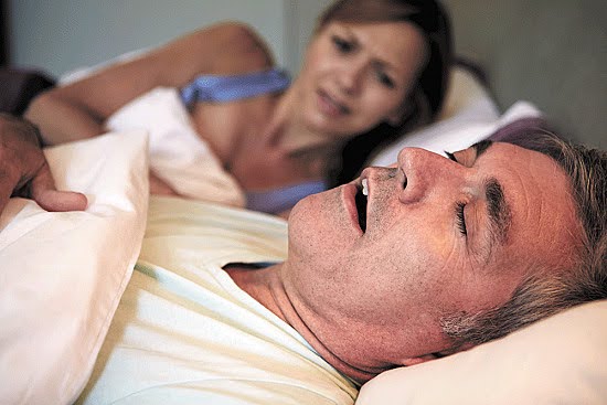 A Man Snoring Loudly because of obstructive sleep apnea Keeping His Bed Partner From Good Rest