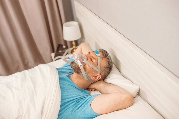 A Picture Showing A Man Using A Sleep Apnea Machine While Peacefully Lying on the Bed
A Picture Showing A Man Using A Sleep Apnea Machine While Peacefully Lying on the Bed