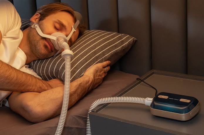 : A Man Sleeping Using A Sleep Apnea Machine : A Man Sleeping Using A Sleep Apnea Machine